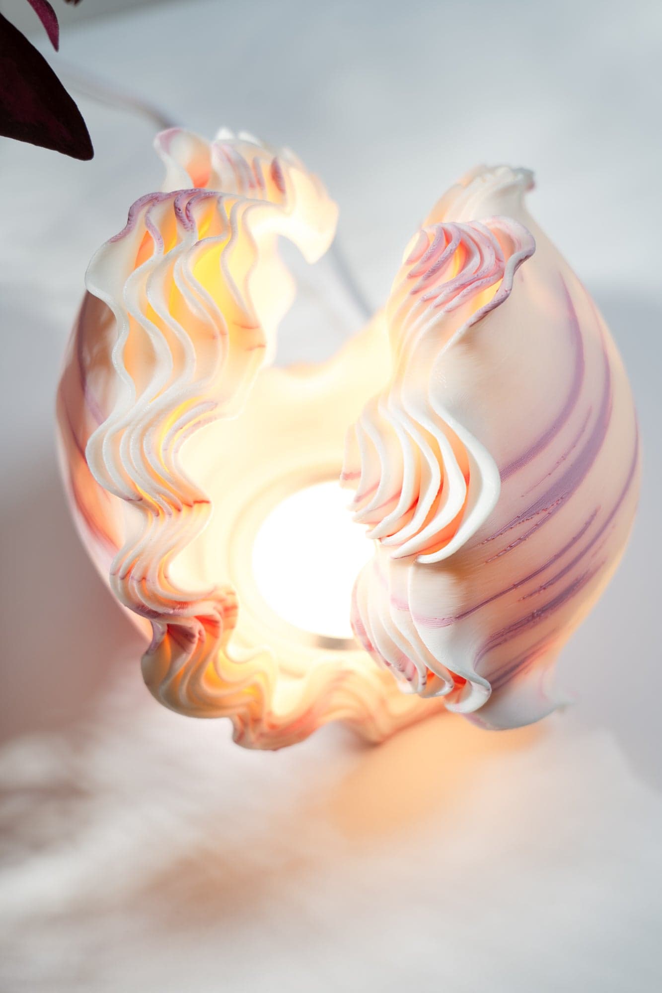 Ocean Petals mini lamp on a wooden table with plants