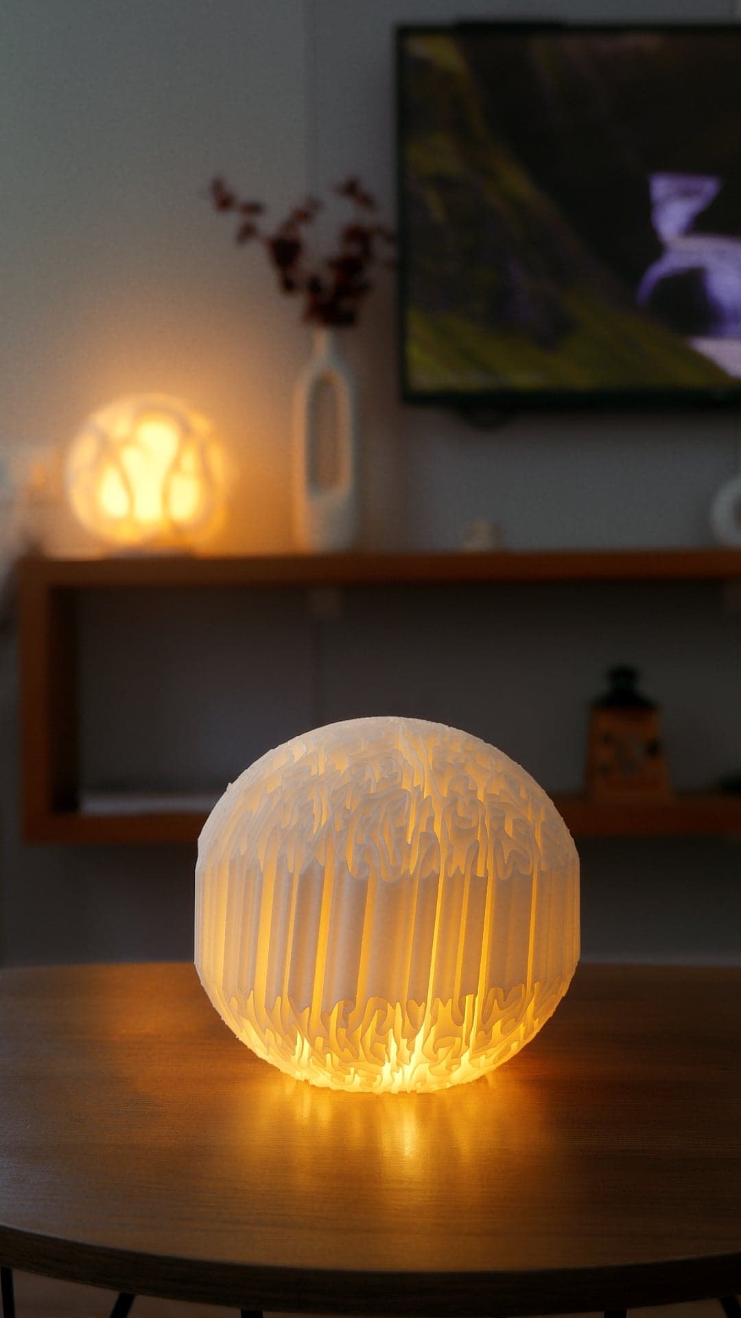 Biomorphic mini lamp on a shelf in a dim room